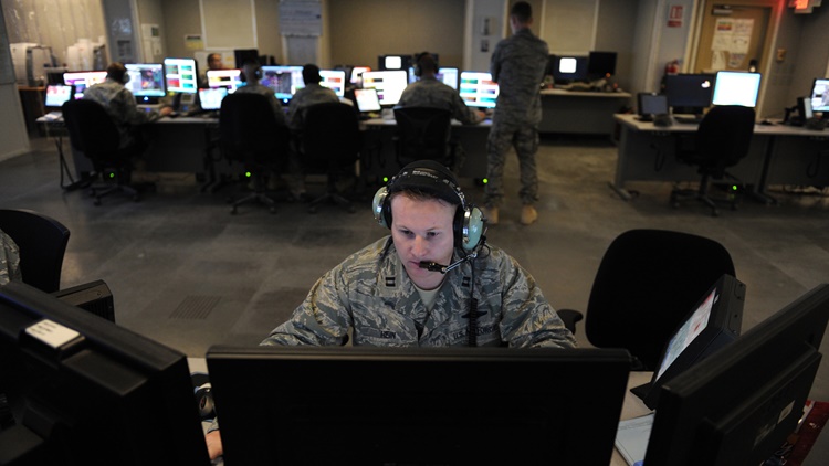 military officer looking at computer screen
