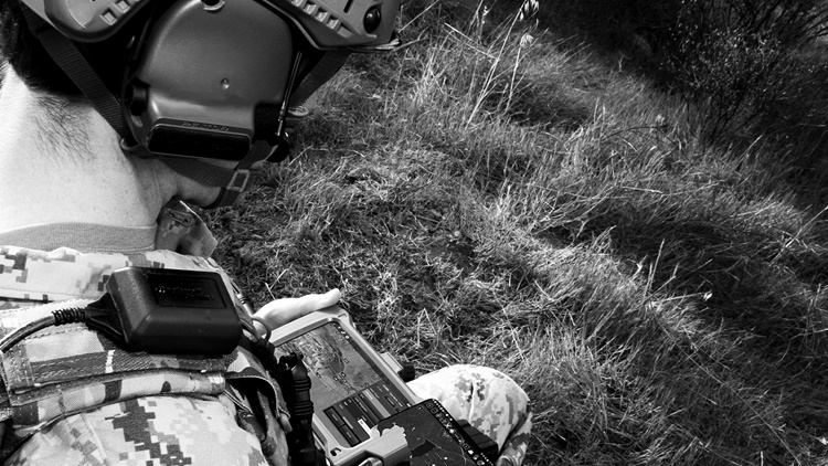 Soldier looking at his FasTAK integrated targeting system